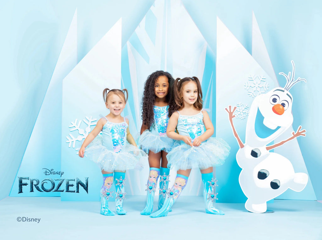 three little girls wearing Frozen Socks, and a snowman