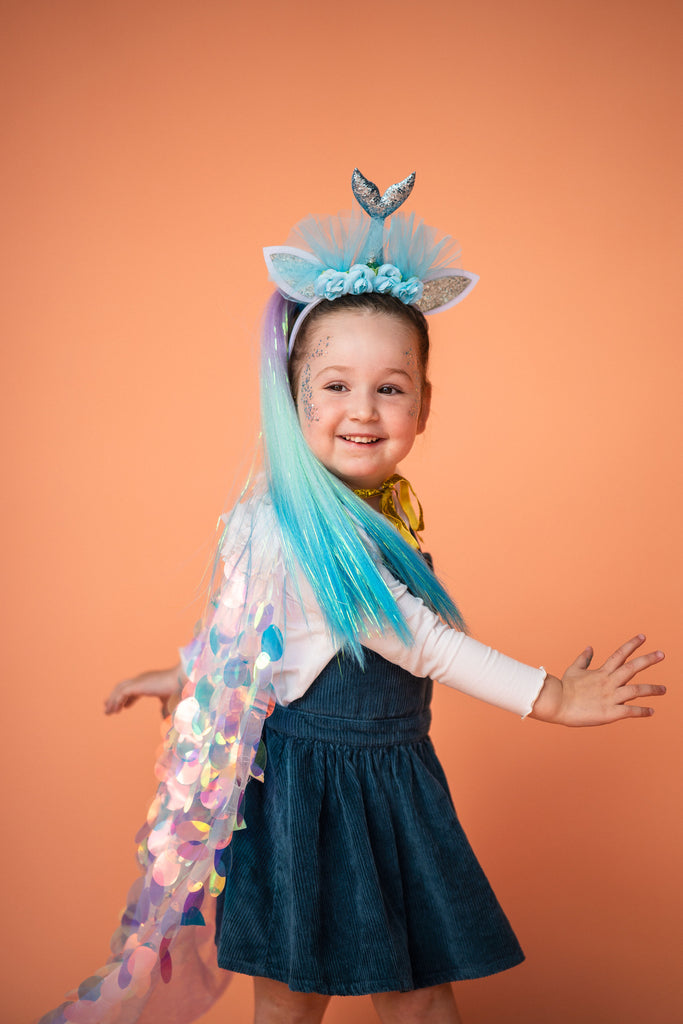 little girl is standing while using Mermaid Headband -  Light Blue
