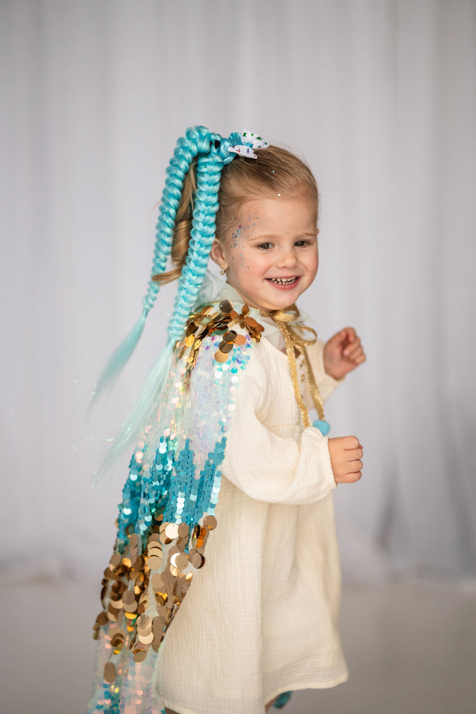 little girl is wearing Blue Sequin Cape