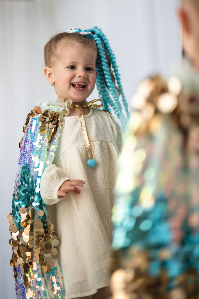 girl wearing Blue Sequin Cape