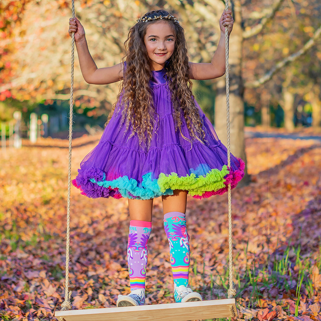 little girl enjoying swings while wearing  Mini Pony Socks