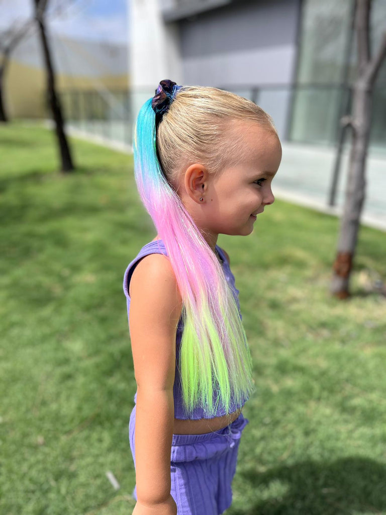little girl wearing rainbow ponytail