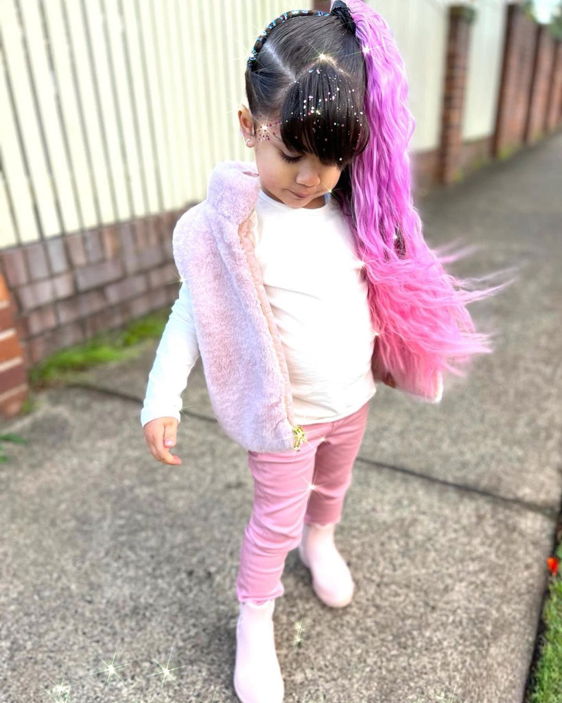 little girl is posing while wearing Coral Wavy Mermaid Ponytail