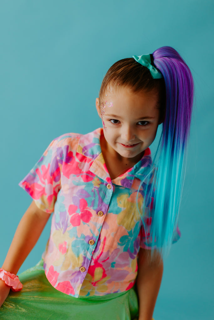 a standing girl, having Luna Straight Clip in Ponytail
