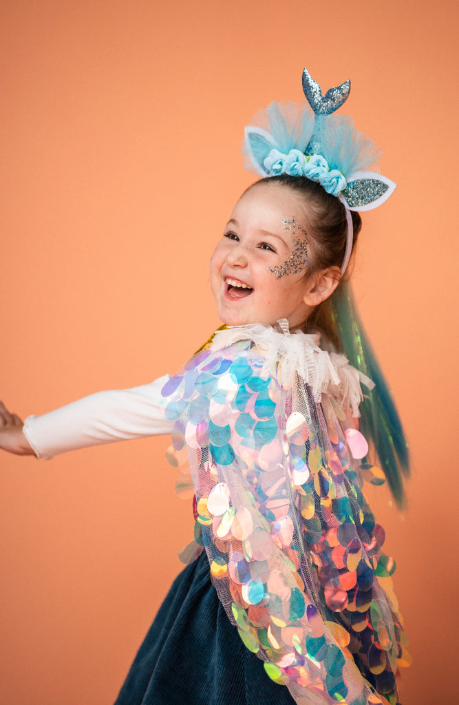 a laughing girl wearing Opal Sequin Cape