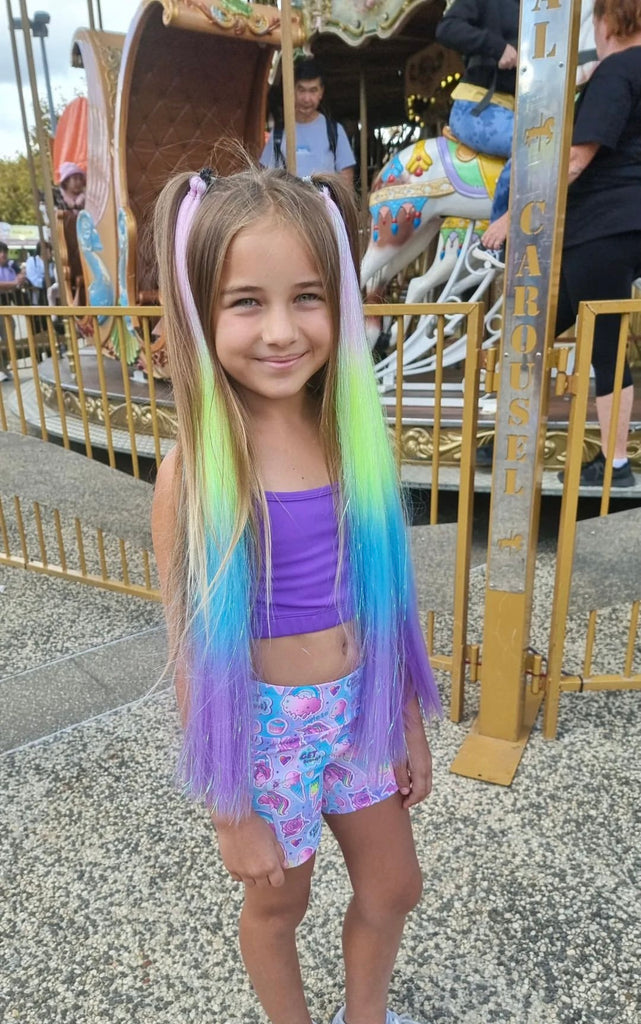 a standing girl with Rainbow Sherbet Straight Set tie in her hairs